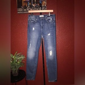 H&M. Size 30. Medium blue skinny denim with intentional rips on front side.